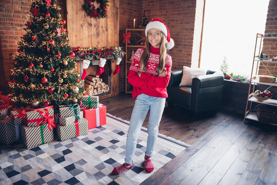Photo of confident pretty little lady dressed red print pullover arms folded enjoying x-mas christmas spirit indoors home room