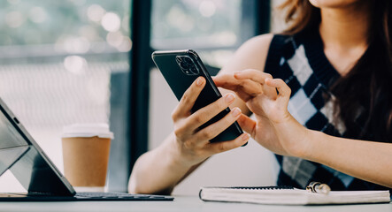 Entrepreneur Asian businessman and businesswoman discussing new business project in tablet in modern Meeting In Modern Office, Asian business casual concept.