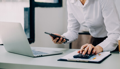 Fototapeta premium Entrepreneur Asian businessman and businesswoman discussing new business project in tablet in modern Meeting In Modern Office, Asian business casual concept.