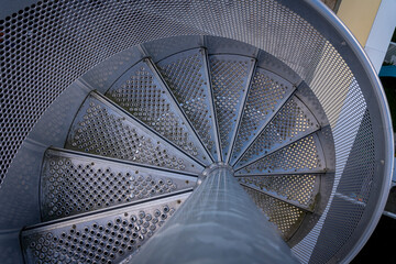 Obraz premium Ivry-Sur-Seine, France - 09 27 2021: View of a circular metal staircase seen from above.