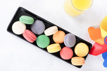 Assorted macaron cookies on a white background.