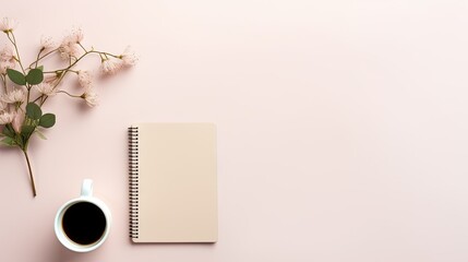  a cup of coffee next to a notepad and a vase of flowers on a pink background with a spiral notebook.