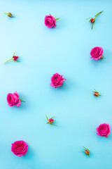 Pink flowers and buds on blue background. Vertical floral pattern. Selective focus