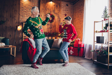 Full size portrait of two excited funky overjoyed people enjoy dancing domestic christmastime disco indoors