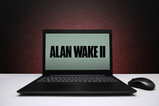Alan Wake 2 game on laptop screen with mouse on black textured wall with red light. Astana, Kazakhstan - November 13, 2023.