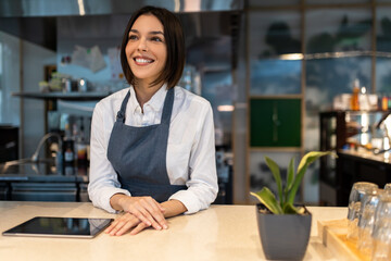 Pretty dark-haired young girl in a coffee shop