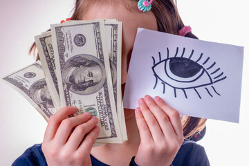 Conceptual image of young girl holding US Dollar money and banner with open eye as symbol: money...