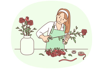 Female florist working with flowers in workshop