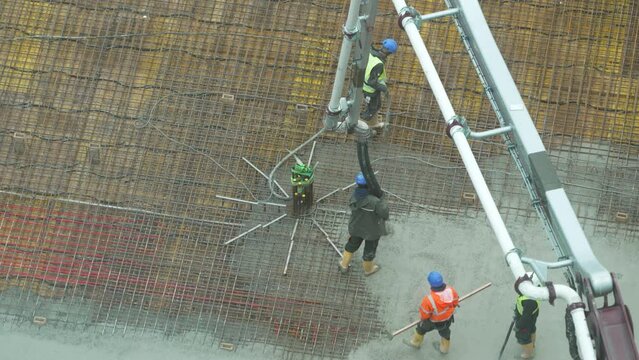 building a floor by pumping liquid concrete for Concreting on a construction site