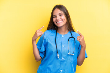 Young nurse caucasian woman isolated on yellow background giving a thumbs up gesture