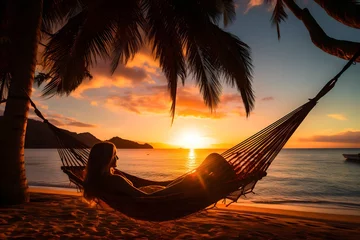 Foto op Aluminium Woman relaxing in a hammock on the beach at sunset © Salsabila Ariadina
