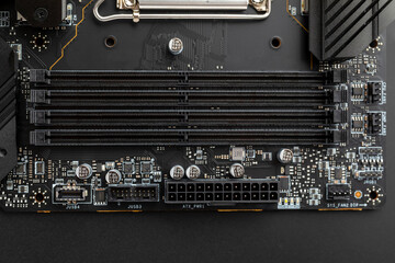 24 pin ATX power connector, DDR5 contacts on the motherboard on black background