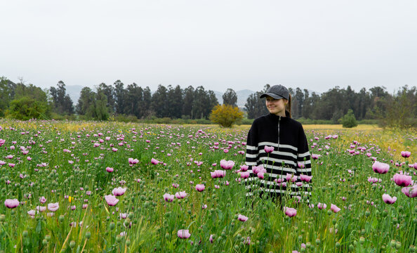 Portrait of a young woman in a field of flowers.