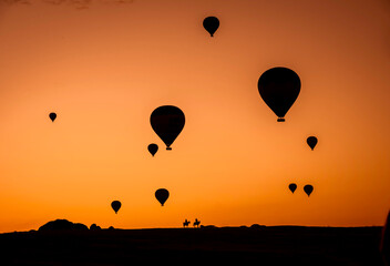 Air balloons at sunset over Cappadocia-Goreme, Turkey, Oct. 20th,2022. A vibrant explosion of light and color, and the enthusiasm of flying an air balloon over the strange rock formation.