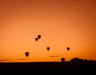 Air balloons at sunset over Cappadocia-Goreme, Turkey, Oct. 20th,2022. A vibrant explosion of light and color, and the enthusiasm of flying an air balloon over the strange rock formation.