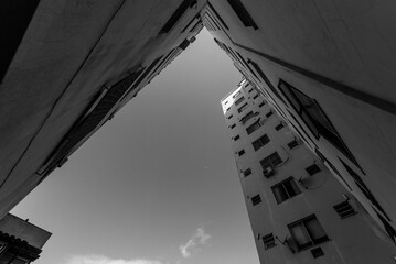 Low angle grayscale shot of buildings