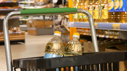 Close-up of two sunflower oil bottles in a shopping cart