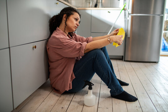 Woman Taking a Break from Cleaning Kitchen