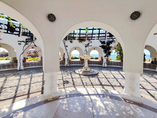 The main rotunda inside the Kallithea Springs with the fountain and mosaic floor made from round beach pebbles. Rhodes, Greece.