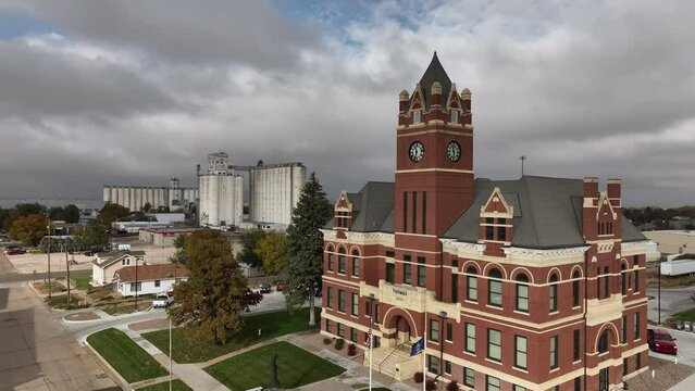 Flying past the Colby City courthouse viewing silos across town in Kansas.