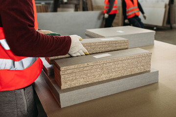 A worker prepares PVC furniture boards for packaging