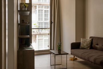 Interior design of a cozy living room with a stylish sofa, coffee table, flowers, decorations