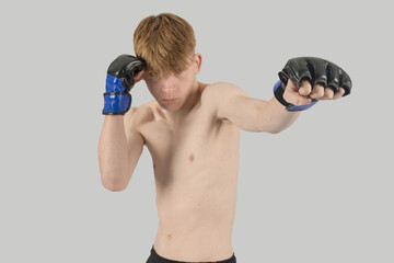 Shirtless male teenage MMA fighter