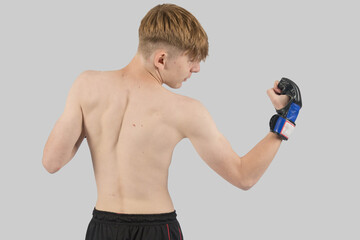 Shirtless male teenage MMA fighter