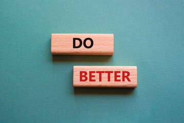Do better symbol. Wooden blocks with words Do better. Beautiful grey green background. Business and Do better concept. Copy space.