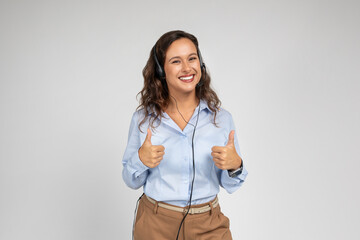Smiling friendly young caucasian lady manager, teacher in formal wear show thumb up sign with hands