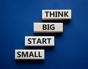 Think big start small symbol. Concept words Think big start small on wooden blocks. Beautiful deep blue background. Business and Think big start small concept. Copy space