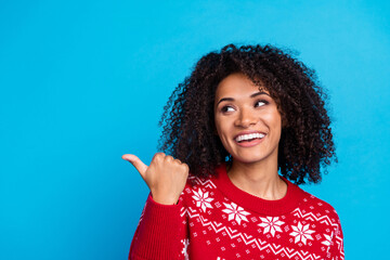 Photo of funny youth girlfriend wearing red pullover indicating finger mockup happy new year greetings isolated on blue color background