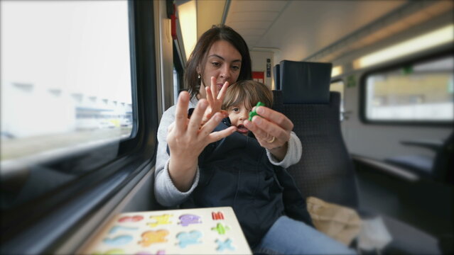 Dedicated mom imparting counting lessons to her child on a train, exemplifying mobile education and the role of a hands-on parent