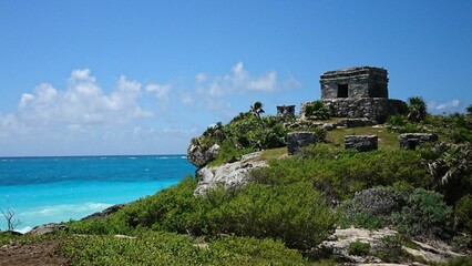 Ancient Temple of the Wind God in Mayan Tulum city in Mexico with the sea in the background