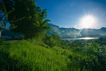 The strong sun falls on the city of Tingo Maria creating a beautiful atmosphere, in Peru. - obrazy, fototapety, plakaty