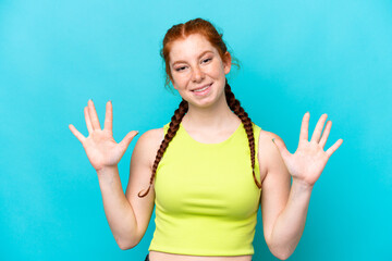 Fototapeta premium Young reddish woman isolated on blue background counting ten with fingers