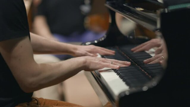 A jazz pianist playing the piano during a combo rehearsal