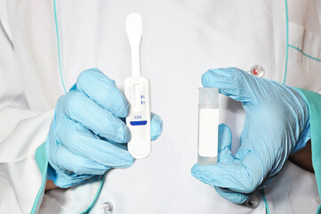 Express test for HIV/AIDS in the hands of a doctor. Close-up