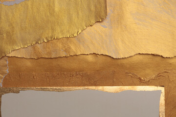 Gold, bronze and beige paper collage paper frame painting wall. Abstract glow texture copy space...