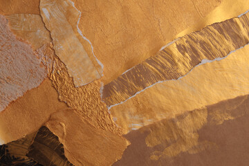 Gold, bronze and brown paper paper torn frame painting wall. Abstract texture copy space background.