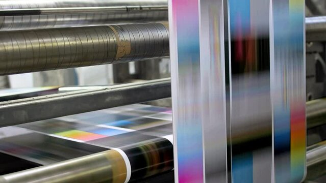 Flyers, newspapers, leaflets on the conveyor belt in a printing house