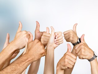 Thumbs up, human hands team together