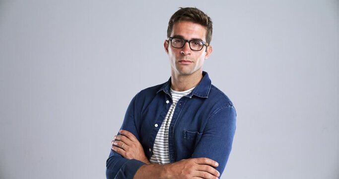 Man, face and glasses with arms crossed in studio, pride attitude and confident by gray background. Person, portrait and mindset for vision with eyewear, fashion frame and optometry in mockup space