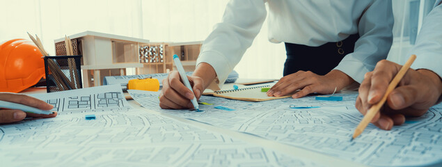 Worker, architect and engineer work on real estate construction project oratory planning with...