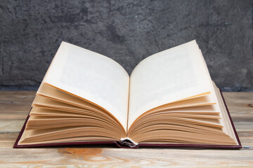 open book on the background of the gray concrete background. Back to school. Education. Copy space for text.