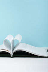 Old open hardback book, page decorate into a heart shape for love in Valentine's. love with open book heart.