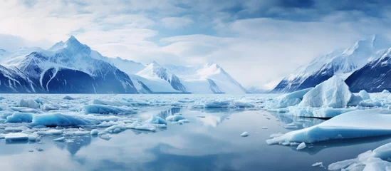 Zelfklevend Fotobehang The stunning landscape of Alaska in winter with its white and blue snowy scenery is truly a sight to behold filled with beautiful glaciers icebergs and icy terrain showcasing the raw power a © TheWaterMeloonProjec