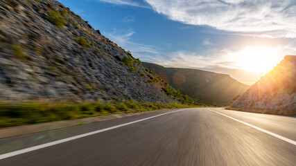 Mediterranean sea coast road into mountains horizon in summer with beautiful bright sun rays