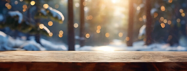 Empty wooden table top with blur background of snowy winter forest. Panorama for product advertising.