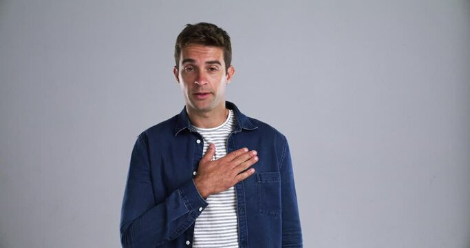 Face, sick and man with a cough, allergy and lung disease with bacteria on a grey studio background. Person, guy and model with covid, health issue or infection with a cold, fever and flu with asthma
